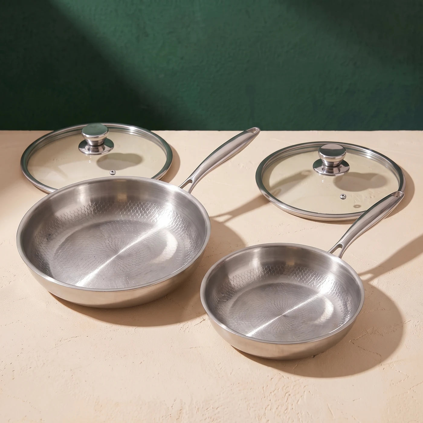 Compact and Everyday Titan pan sizes with their glass lids
