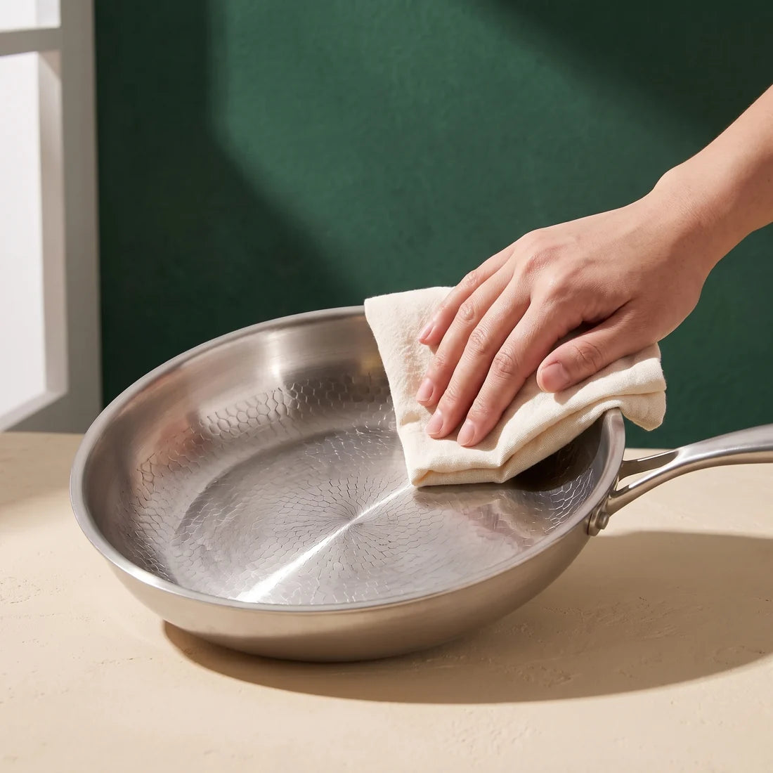 Titan pan being wiped with a soft cloth