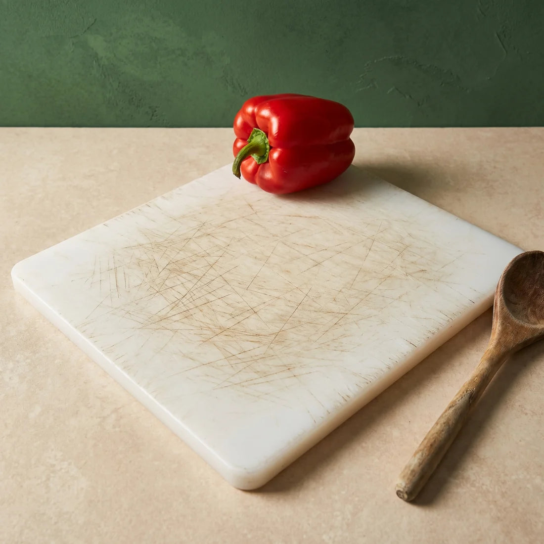 Knife marks on a worn plastic cutting board